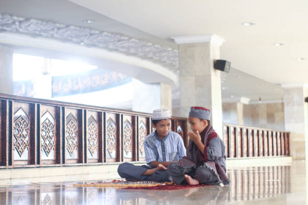 istock Muslim boys salat in the mosque 1372461472