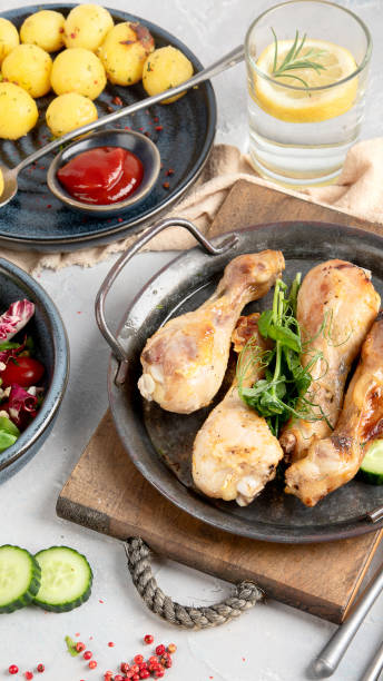 istock Baked chicken legs with salad and potatoes 1372464262