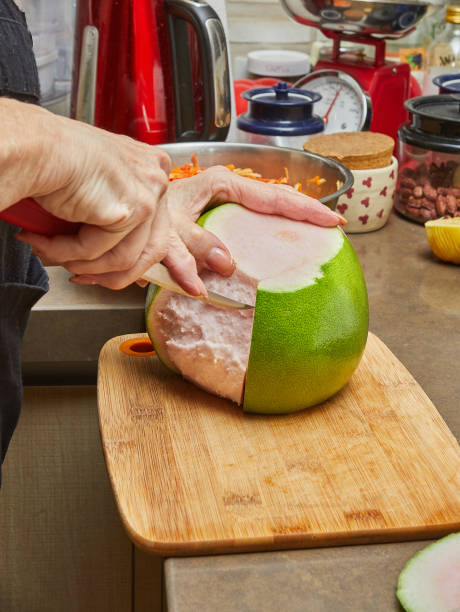 Pomelo red inside the cook cuts into pieces on a cutting board