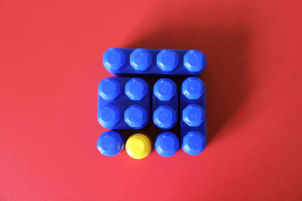 istock Game for children, colored plastic building blocks with a piece of a different color as a concept of unique, extraordinary, lonely and singular 1372468053