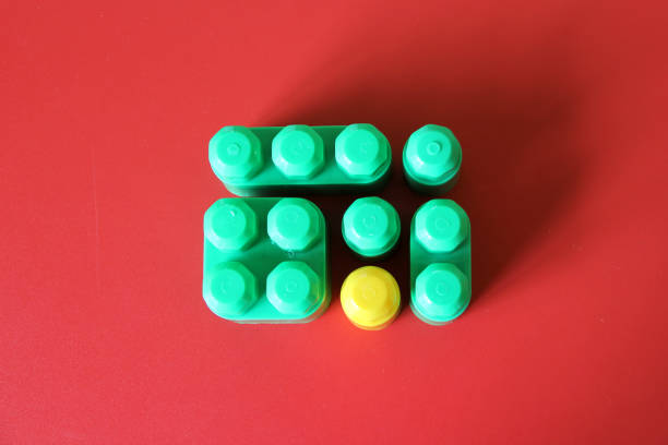 istock Game for children, colored plastic building blocks with a piece of a different color as a concept of unique, extraordinary, lonely and singular 1372468054