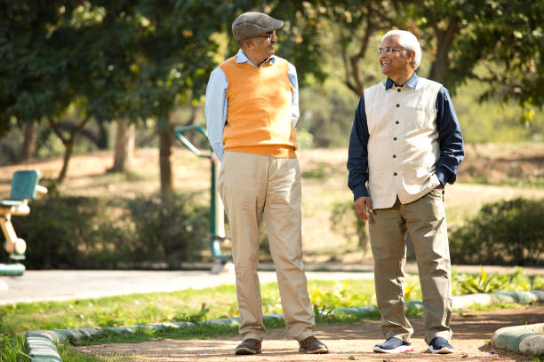 istock Two senior men looking at each other in park 1372469278
