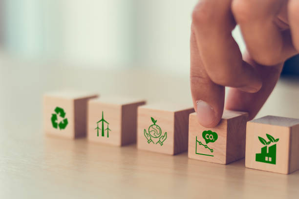 istock Net zero and carbon neutral concept. Net zero greenhouse gas emissions target. Climate neutral long term strategy. Hand put wooden cubes with decrease carbon emission icon and green icon. Green banner 1372472078