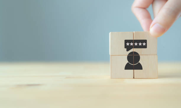 istock Consumer feedback concept.  Customer satisfaction evaluation to improve and develop product and service. Customer centric. Hand puts wooden cubes with 