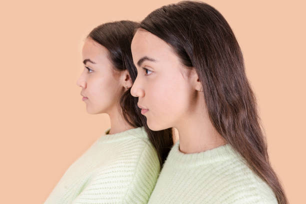 istock close-up profile of two twin sisters 1372472264