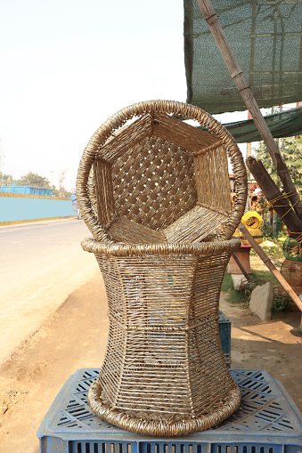 Handmade bamboo sitting stool/mudda for sale on roadside outdoors. Bunch of Eco friendly Handicraft Hand-Woven Bamboo & Rope Mudda Chair for Indoor and Outdoor.