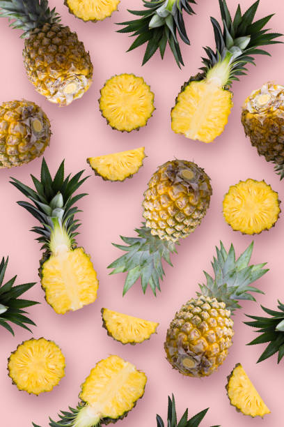 istock Pineapple fruit and Pineapple slices wallpaper on a pink background. 1372474383