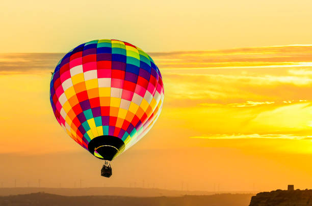 Three balloons flying during a beautiful sunset