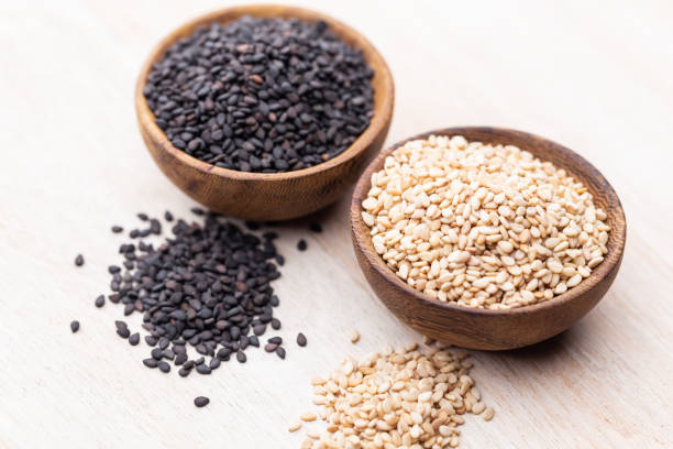 istock White sesame and black sesame seed on wooden bowl. 1372477225
