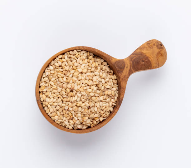 istock Bio natural sesame seeds on wooden bowl. 1372477371
