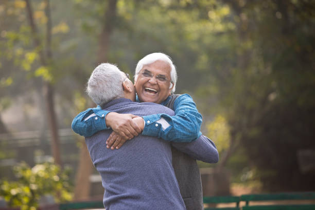 istock Two senior men embracing at park 1372478226
