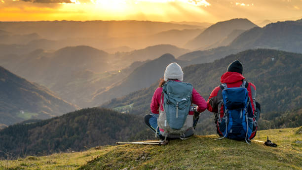istock Couple talking with each other on mountain top 1372478588
