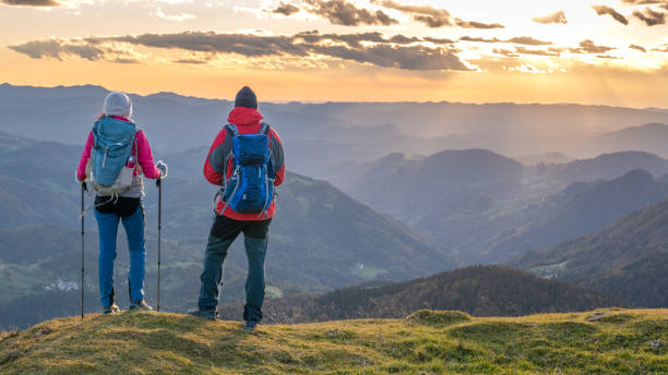 istock Couple standing and looking at mountain view 1372478590