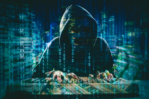 Double exposure of hooded hacker stealing information data in the cyberspace with binary code and night city background