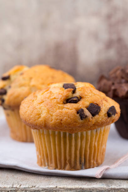 istock Homemade muffins with chocolate, vintage background. 1372479560