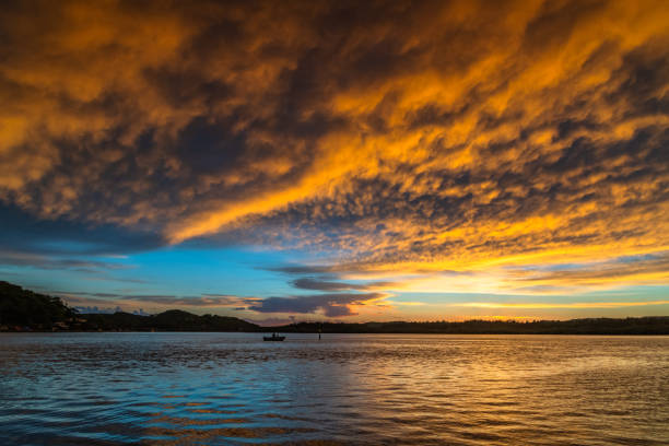 istock Sunrise by the bay with cumulonimbus clouds 1372480043