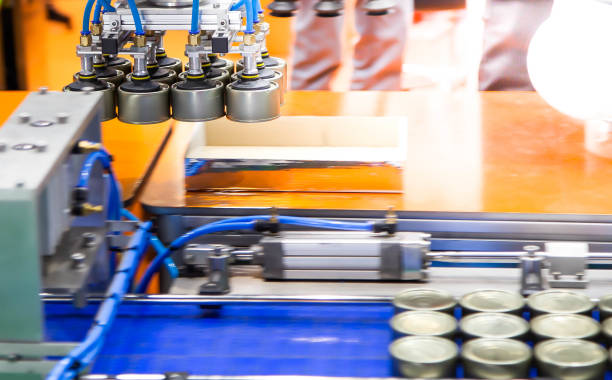 istock Automation robot lifting food can 1372480046