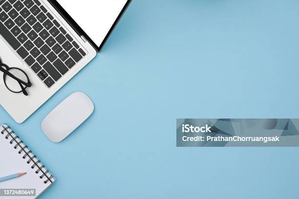 Mock Up Laptop Computer Wireless Mouse And Notebook On Blue Background Stock Photo - Download Image Now