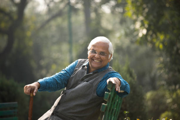 istock Happy senior man sitting at park 1372480942