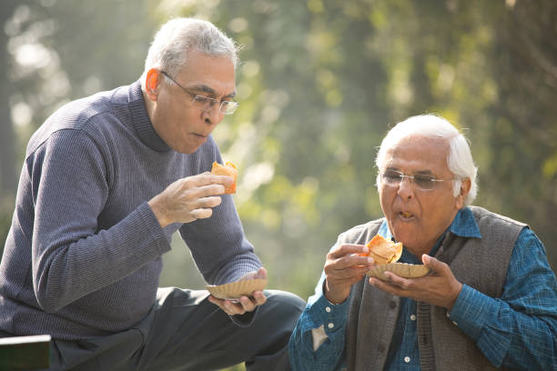 istock Two senior men having fun at park 1372481120