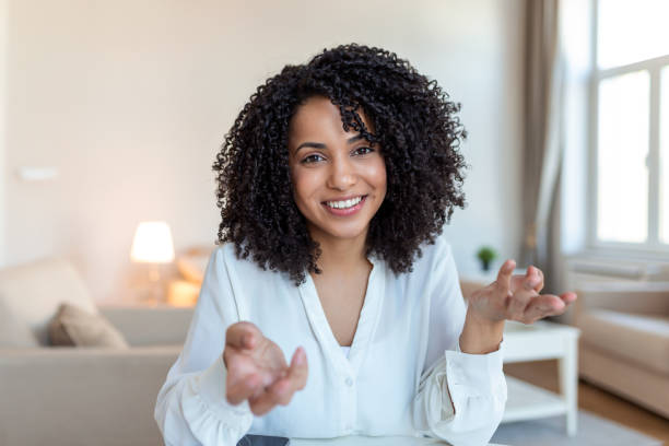 istock African-american elegant female entrepreneur discussing while having a conference call Portrait of confident ethnicity female employee looking at camera talking on video call in the home office. 1372481302
