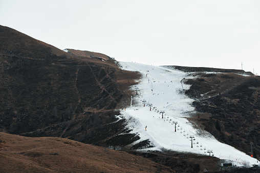 Ski slope with only artificial snow in a dry winter