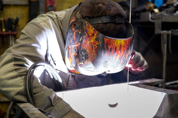 Welding a pallet from an aluminum engine TIG welder performs welding repair of the engine pallet welder engineering construction bright stock pictures, royalty-free photos & images