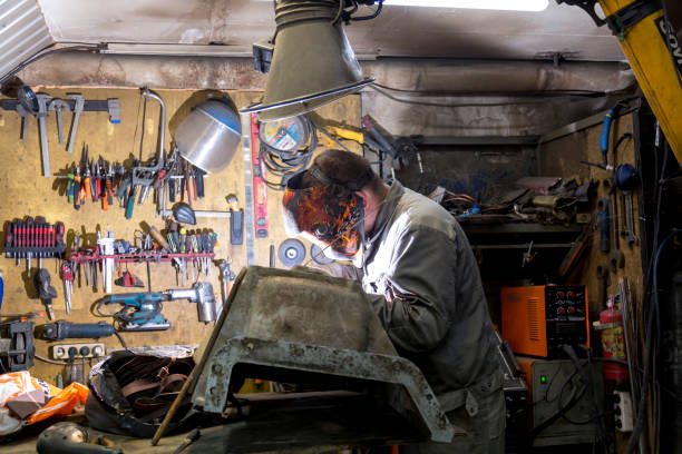 Welding a pallet from an aluminum engine TIG welder performs welding repair of the engine pallet welder engineering construction bright stock pictures, royalty-free photos & images