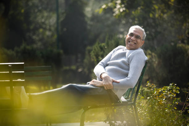 istock Happy senior man relaxing at park 1372485670