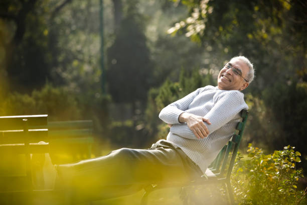 istock Happy senior man relaxing at park 1372485685