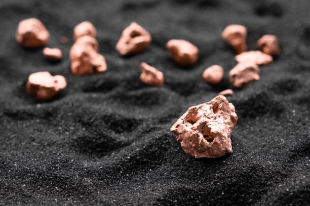 The lumps of copper ore from the excavated mine were placed on the black sand. The lumps of copper ore from the excavated mine were placed on the black sand. copper mine stock pictures, royalty-free photos & images