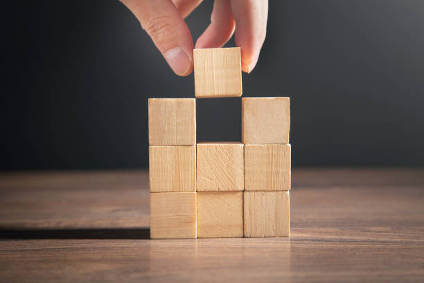 istock Male hand stacking wooden empty cubes. 1372488150
