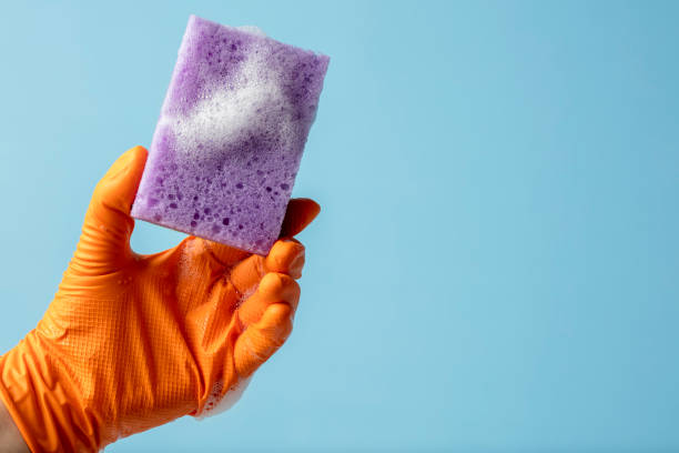 istock Hand holding a cleaning sponge with soap sud 1372489965