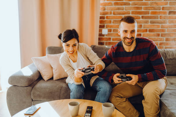 istock Young couple playing video games 1372492517