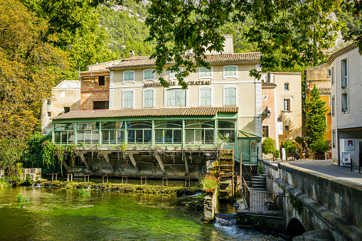Terrace of a restaurant by the Sorgue river in the village of Fontaine de Vaucluse in Provence, France