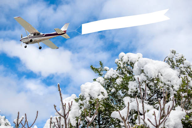 istock Airplane with banner to snowy day 1372493769