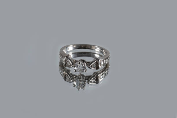 istock White gold ring with natural diamonds with reflection on a gray background 1372495787
