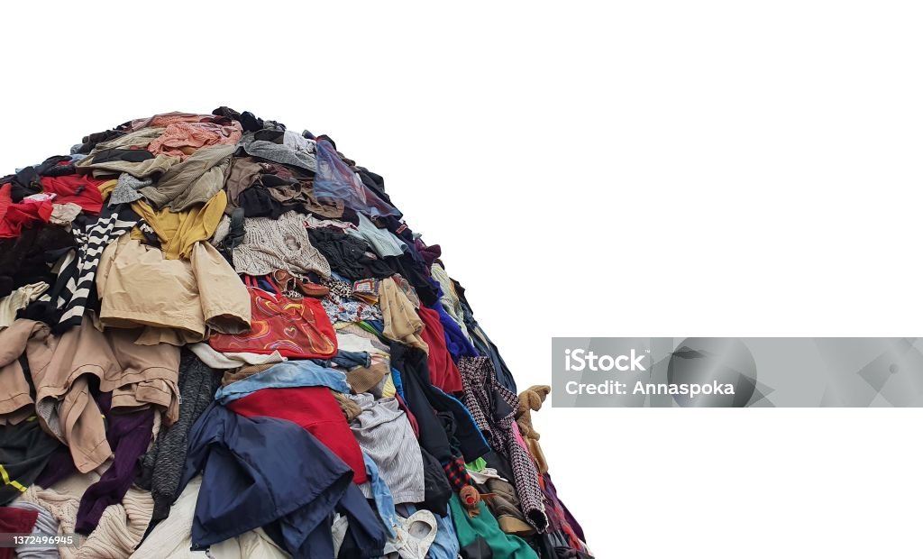 large pile stack of textile fabric clothes and shoes. concept of recycling, up cycling, awareness to global climate change, fashion industry pollution, sustainability, reuse of garment. Clothing Stock Photo