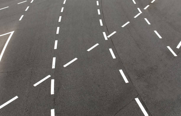 istock black asphalt road and white dividing lines 1372497009