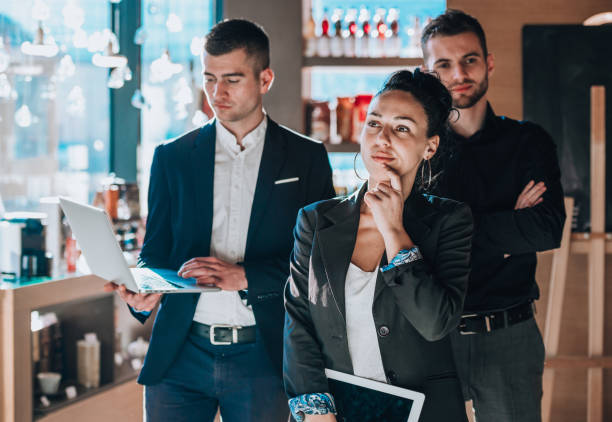 Work colleagues holding tablet and laptop