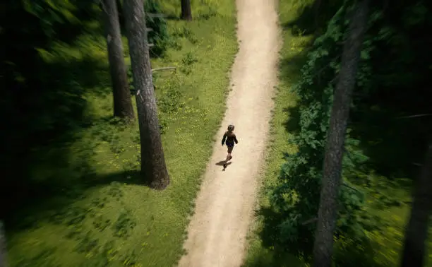 Woman with blonde hair in black top and short jeans walks on a trail in a pine forest on a sunny summers day. Aerial view. 3D render.