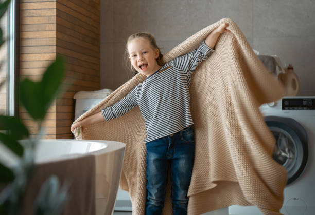 istock girl is playing in the laundry room 1372500433