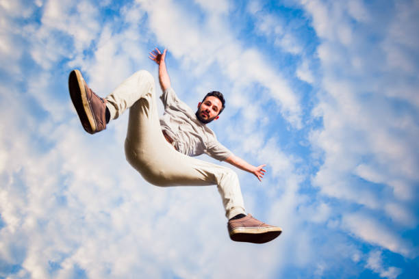 istock Cheerful parkour man below blue sky doing parkour 1372503644