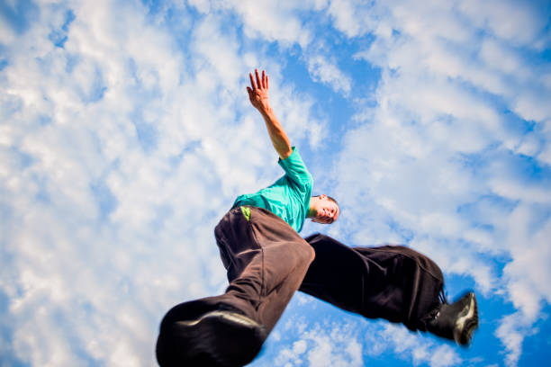 istock Adult man practicing parkour while jumping in the air 1372503673