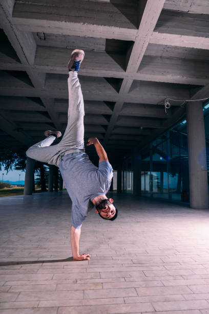 istock Young man exercising handstand at urban place 1372503706