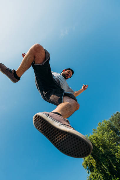 Young man doing parkour jumping at skatepark