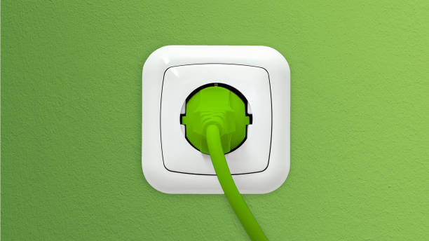 istock White socket with a green plug and cable on a green wallpapered wall 1372504163