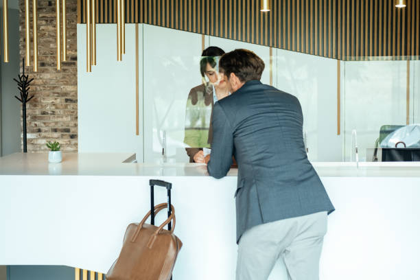 istock Female Hotel Receptionist Assisting Businessman for Checking In 1372506154