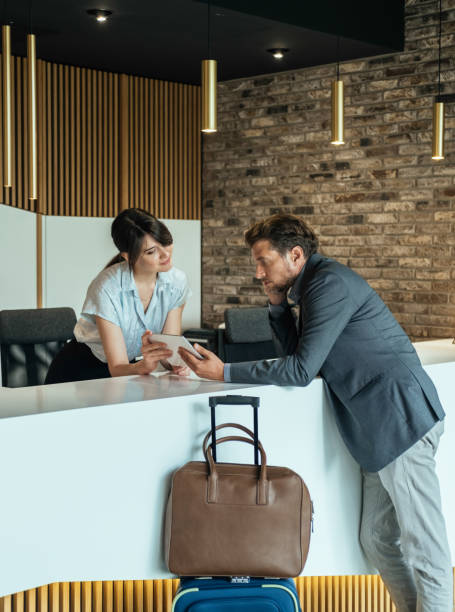 istock Businessman Using Digital Tablet to Checking In at Hotel 1372506158