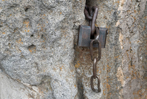 istock old iron castle on a stone wall. iron chain 1372510561